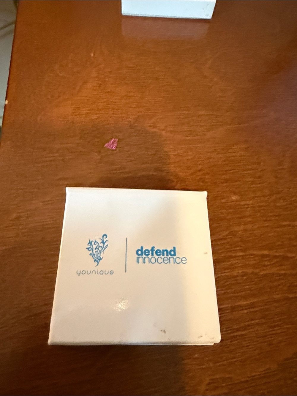 Younique White Compact Case with Blue Defend Innocence Logo
